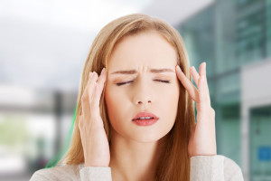 Young woman with huge head ache